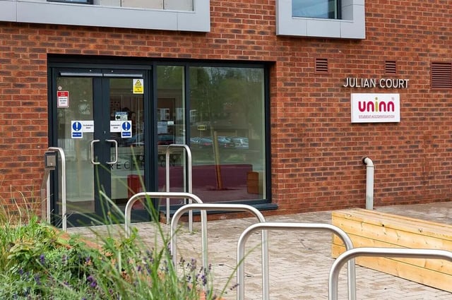 Building entrance with signage and bike racks exterior at Julian Court in Coventry Student Accommodation