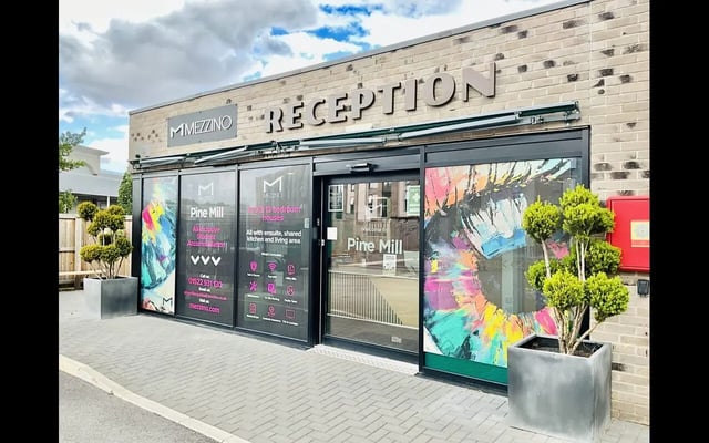 Entrance with reception signage and potted plants exterior at Pine Mill in Lincoln Student Accommodation