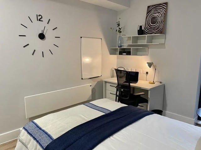 Bed whiteboard desk chair laptop artwork Bedroom at Hydrogen Falmouth in Falmouth Student Accommodation
