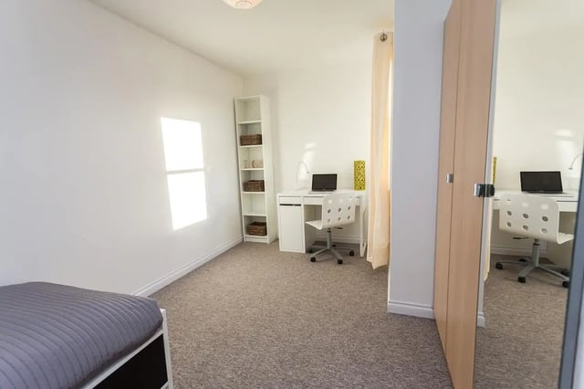 Bed desk bookshelf and laptop bedroom at Froghall in Aberdeen Student Accommodation