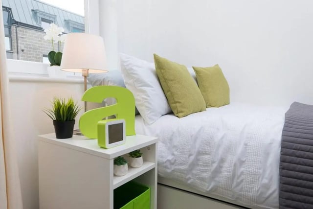 Bed with green pillows and a nightstand bedroom at Froghall in Aberdeen Student Accommodation