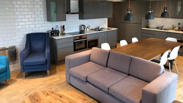 Sofa chairs table kitchen dining area living room at CityBlock Penny Street in Lancaster Student Accommodation