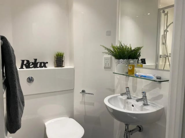 Toilet sink plants and towel bathroom at CityBlock Penny Street in Lancaster Student Accommodation