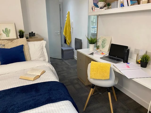 Bed desk and chair with laptop and books Bedroom study area at CityBlock Penny Street in Lancaster Student Accommodation