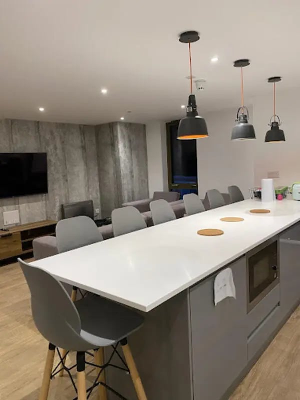 Island with stools and sofa viewing area kitchen at CityBlock Marton Street in Lancaster Student Accommodation