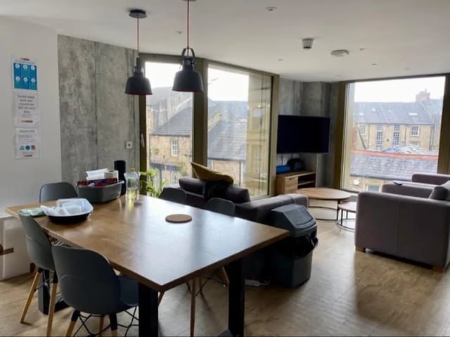 Dining table sofas TV and large windows living room at CityBlock Marton Street in Lancaster Student Accommodation