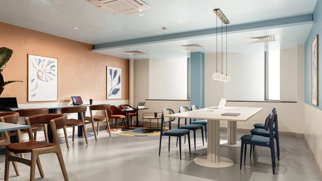 Modern communal area with tables chairs and laptops lounge at B16 Studios in Birmingham Student Accommodation