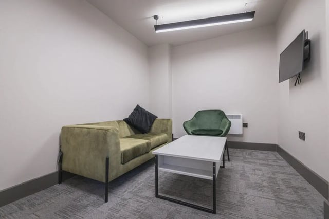 Green sofa black cushion white coffee table living room at The Park in Oxford Student Accommodation