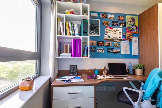 Desk with laptop books and posters Study area at Kaplan Living Glasgow - Old Dumbarton Road in Glasgow Student Accommodation