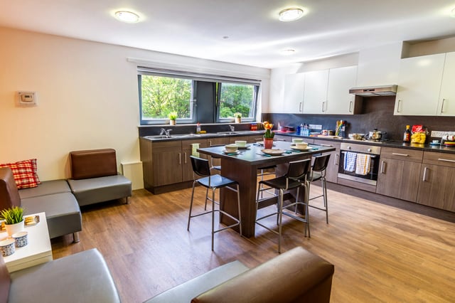 Sofa island dining table chairs kitchen counters cabinets kitchen at Kaplan Living Glasgow - Old Dumbarton Road in Glasgow Student Accommodation