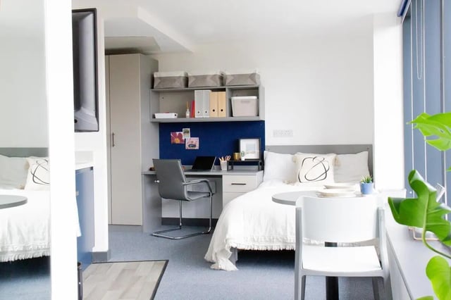 Bed desk shelves chair and TV studio room at Trapezium in Leeds Student Accommodation