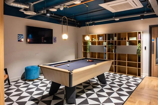 Pool table blue ottoman and bookshelf communal area at Trapezium in Leeds Student Accommodation