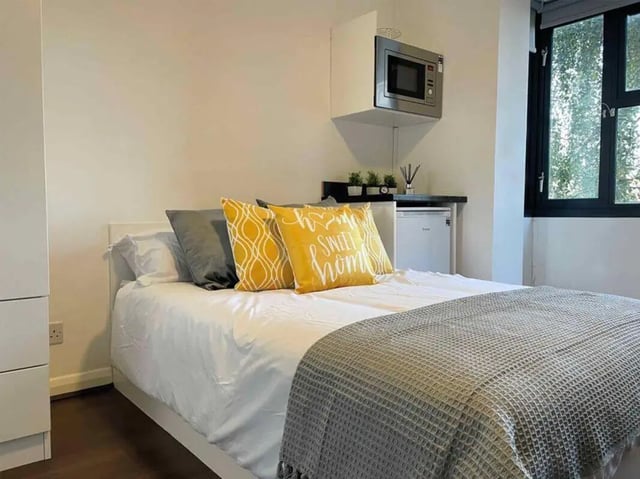 Bed microwave small fridge bedside kitchen bedroom at Hockley Point in Nottingham Student Accommodation