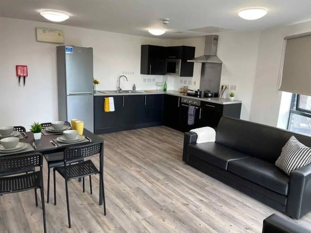 Dining table sofa kitchen appliances living room at Austin Hall in Leeds Student Accommodation