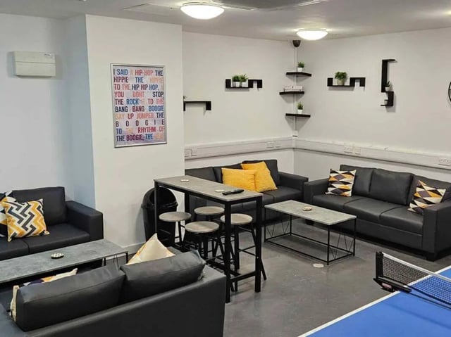 Sofas coffee table and ping pong table living room at Austin Hall in Leeds Student Accommodation