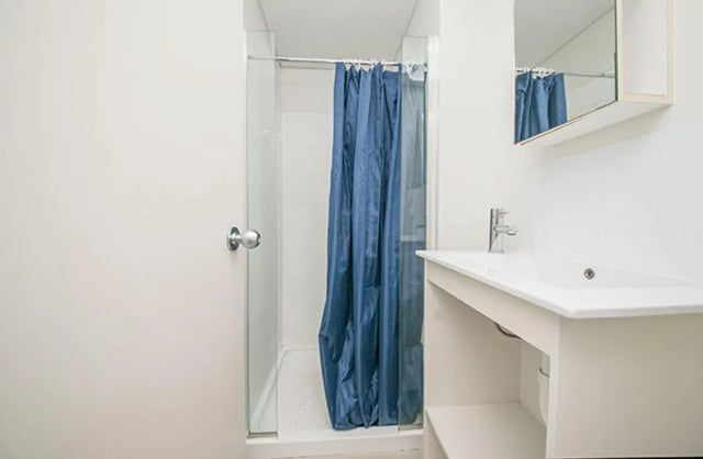 Shower cubicle sink and mirror bathroom at The Collective at Columbia Apartments in Columbia Student Accommodation