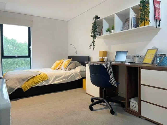 Bed desk chair shelves window bedroom at Asquith House in Leeds Student Accommodation