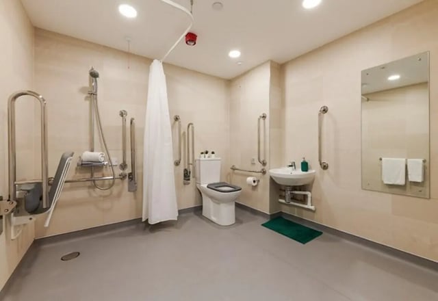 Accessible bathroom with shower toilet sink mirror bathroom at Beckett House in Dublin Student Accommodation