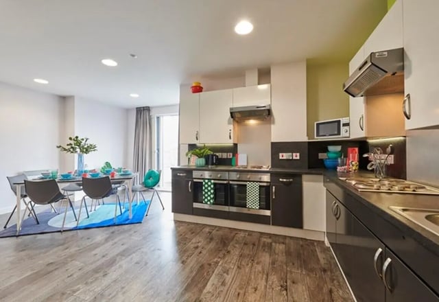 Dining table chairs kitchen with ovens and microwave kitchen at Binary Hub in Dublin Student Accommodation