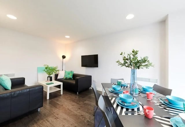 Black sofas white table dining table living room at Binary Hub in Dublin Student Accommodation