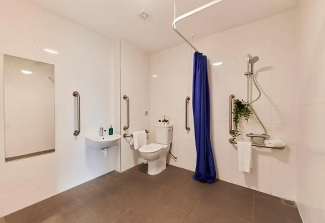 Accessible bathroom with sink toilet shower grab bars Bathroom at Binary Hub in Dublin Student Accommodation