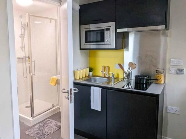 Shower and kitchen area with microwave sink and hob kitchen at Peterson Hall in Dundee Student Accommodation