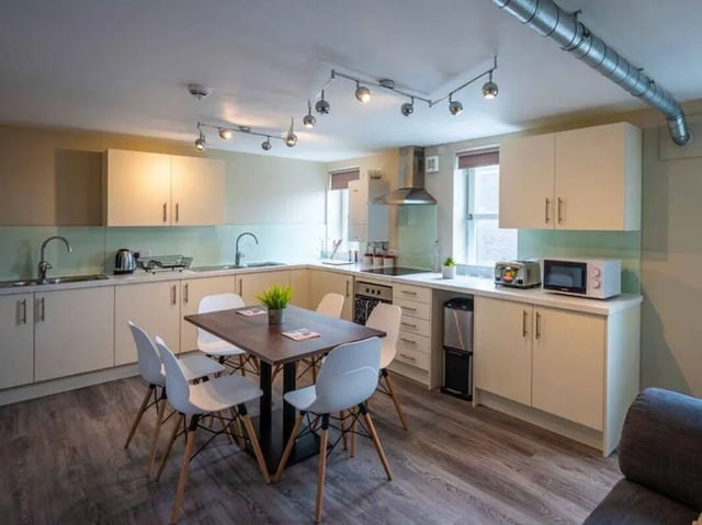 Kitchen with table chairs sink appliances and cabinets Kitchen at Peterson Hall in Dundee Student Accommodation