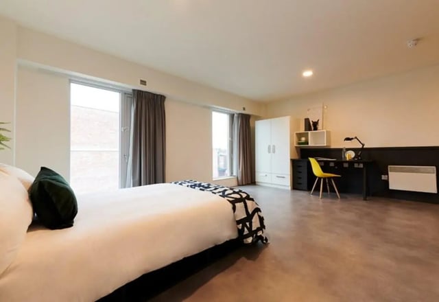 Bed wardrobe desk chair and window bedroom at Dorset Point in Dublin Student Accommodation