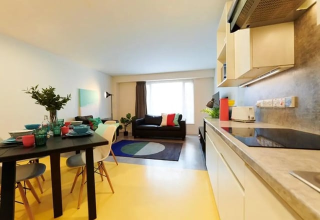 Dining table with place settings and kitchen living room at Dorset Point in Dublin Student Accommodation