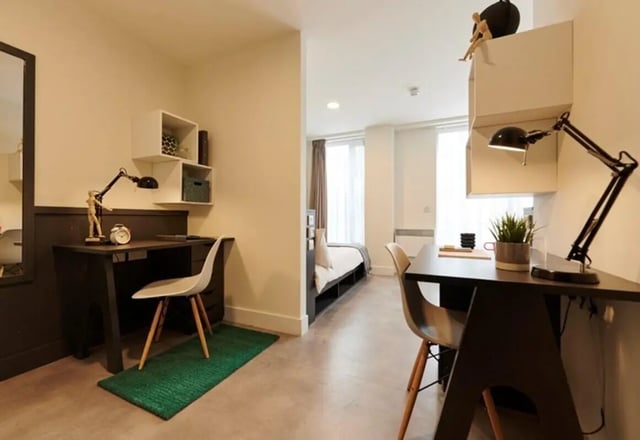 Two desks bedside and wall shelves bedroom at Dorset Point in Dublin Student Accommodation