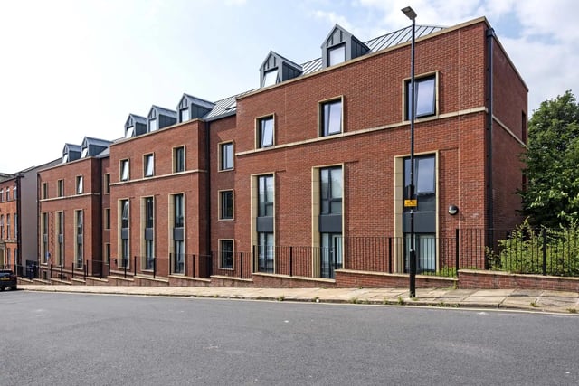Red brick student accommodation with multiple windows exterior at Sycamore House in Leeds Student Accommodation