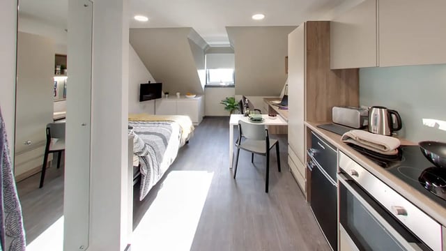 Bed kitchen desk and dining table studio apartment at Sycamore House in Leeds Student Accommodation