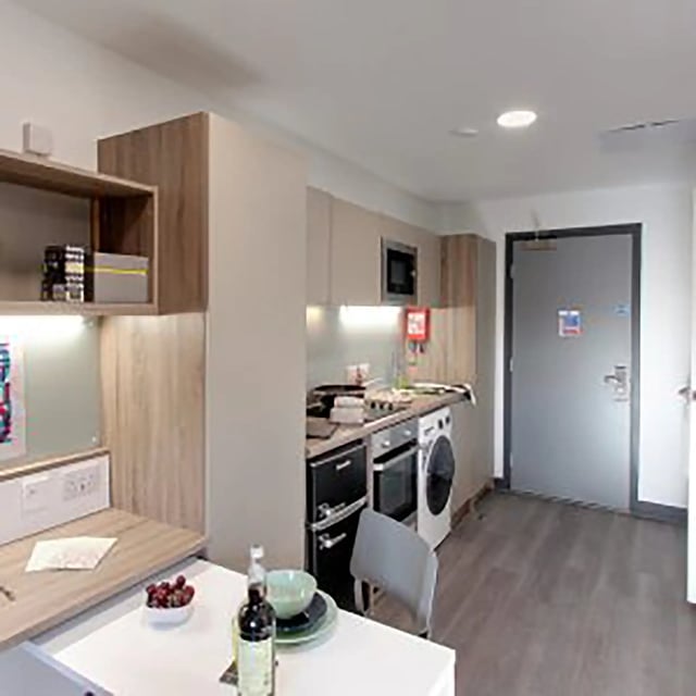 Kitchen with appliances and desk area kitchen at Sycamore House in Leeds Student Accommodation