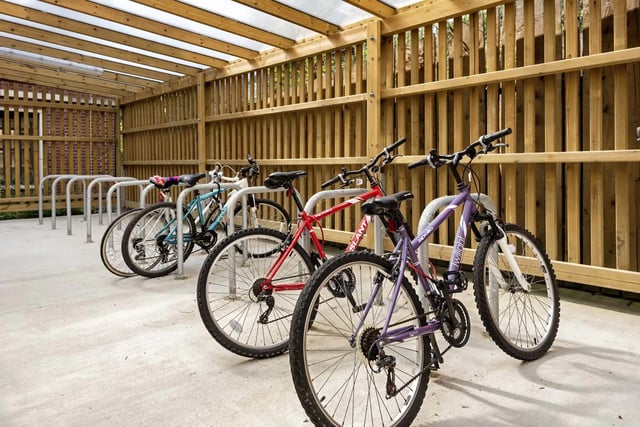 Covered bicycle racks with multiple bikes exterior at Sycamore House in Leeds Student Accommodation