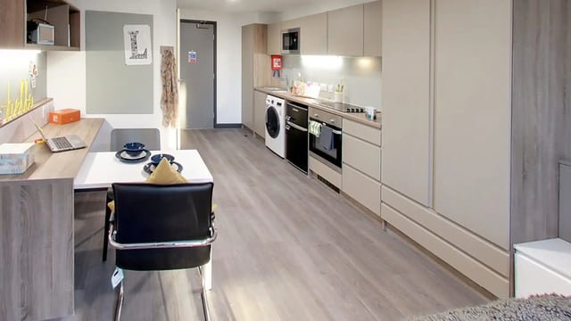Desk laptop table with bowls and chairs kitchen studio apartment at Sycamore House in Leeds Student Accommodation