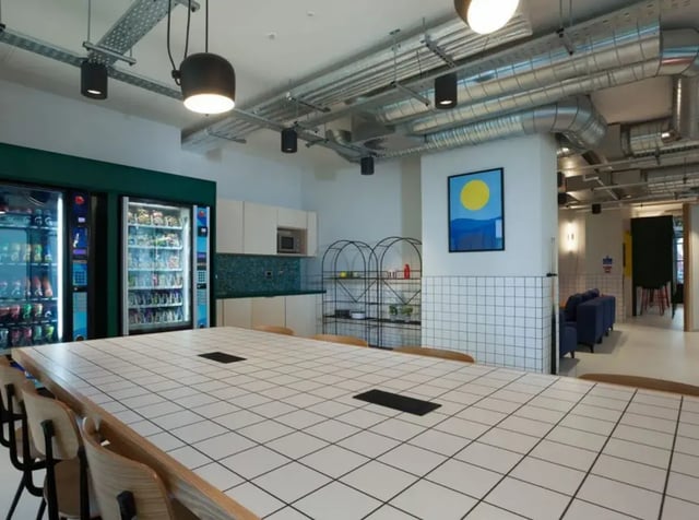 Two vending machines large table and kitchen common area at Highlight Parkgate in Dublin Student Accommodation