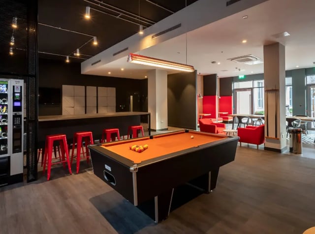 Pool table red stools vending machine common area at Highlight Thomas Street in Dublin Student Accommodation