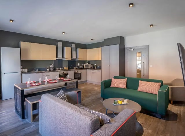 Kitchen diner with sofas and coffee table living room at Highlight Thomas Street in Dublin Student Accommodation