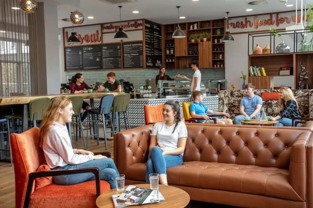 Students relaxing on sofas and at counter lounge at Liv Dublin in Dublin Student Accommodation