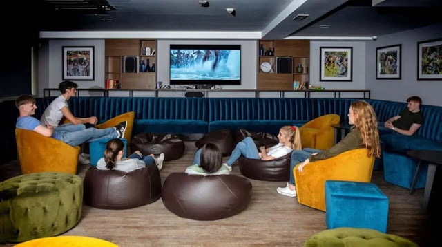 Students relax on beanbags watching TV living room at Liv Dublin in Dublin Student Accommodation