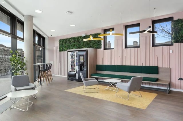 Modern communal area with vending machine and seating. at Highfield House in Dublin Student Accommodation