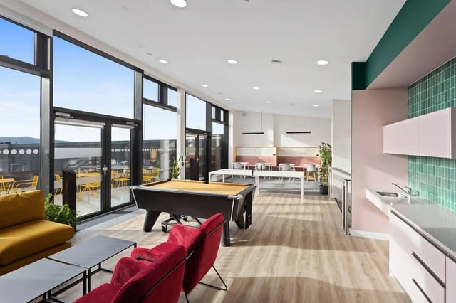 Pool table red chairs yellow couch living room at Highfield House in Dublin Student Accommodation