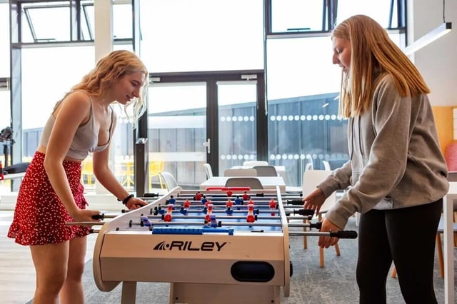 Two students play foosball table games area at Highfield House in Dublin Student Accommodation