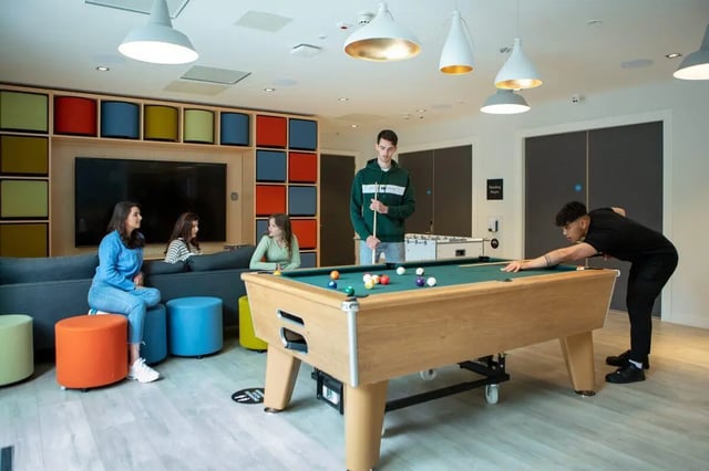 People play pool on a snooker table living room at The Westwood in Galway Student Accommodation