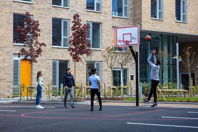 Students playing basketball on court exterior at The Westwood in Galway Student Accommodation