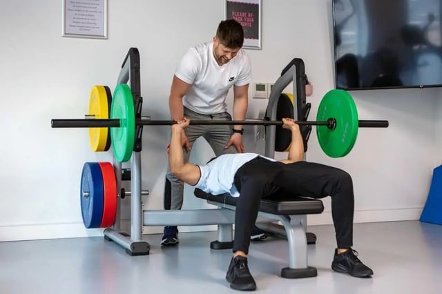 Weightlifting bench with weights and trainer gym area at The Westwood in Galway Student Accommodation