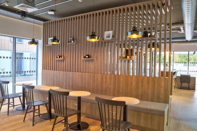 Dining area with benches tables and chairs communal space at Curraheen Point in Cork Student Accommodation