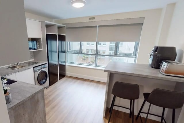 Sink washing machine fridge microwave air fryer toaster kitchen area at Mayor Square in Dublin Student Accommodation