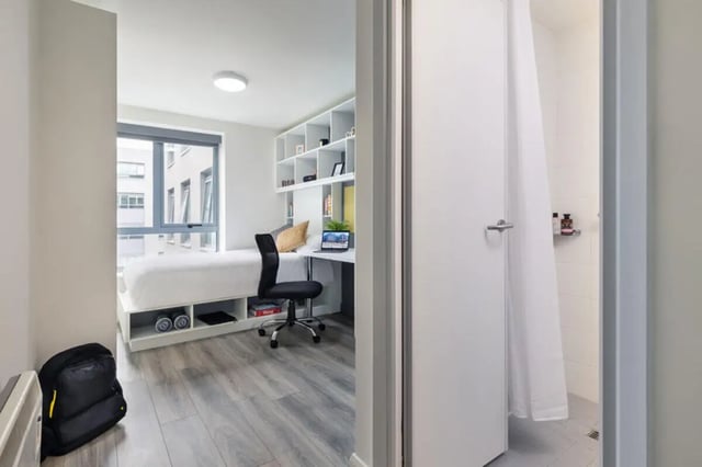 Bed desk shelving unit and shower room at Mayor Square in Dublin Student Accommodation