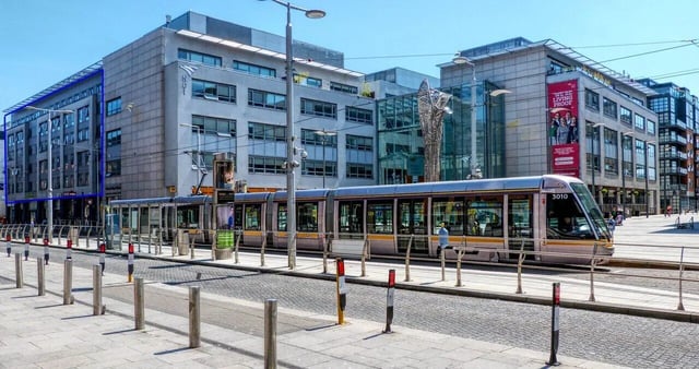Modern buildings tram tracks and streetlights exterior at Mayor Square in Dublin Student Accommodation